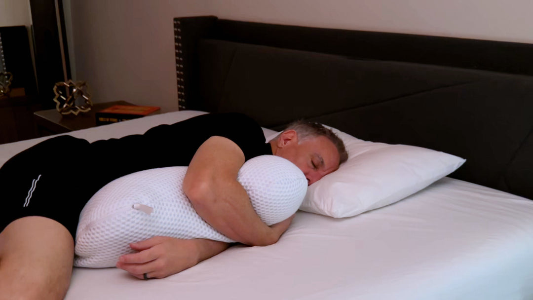a man laying on his side using the clutcher pillow for better sleep and better spinal alignment 