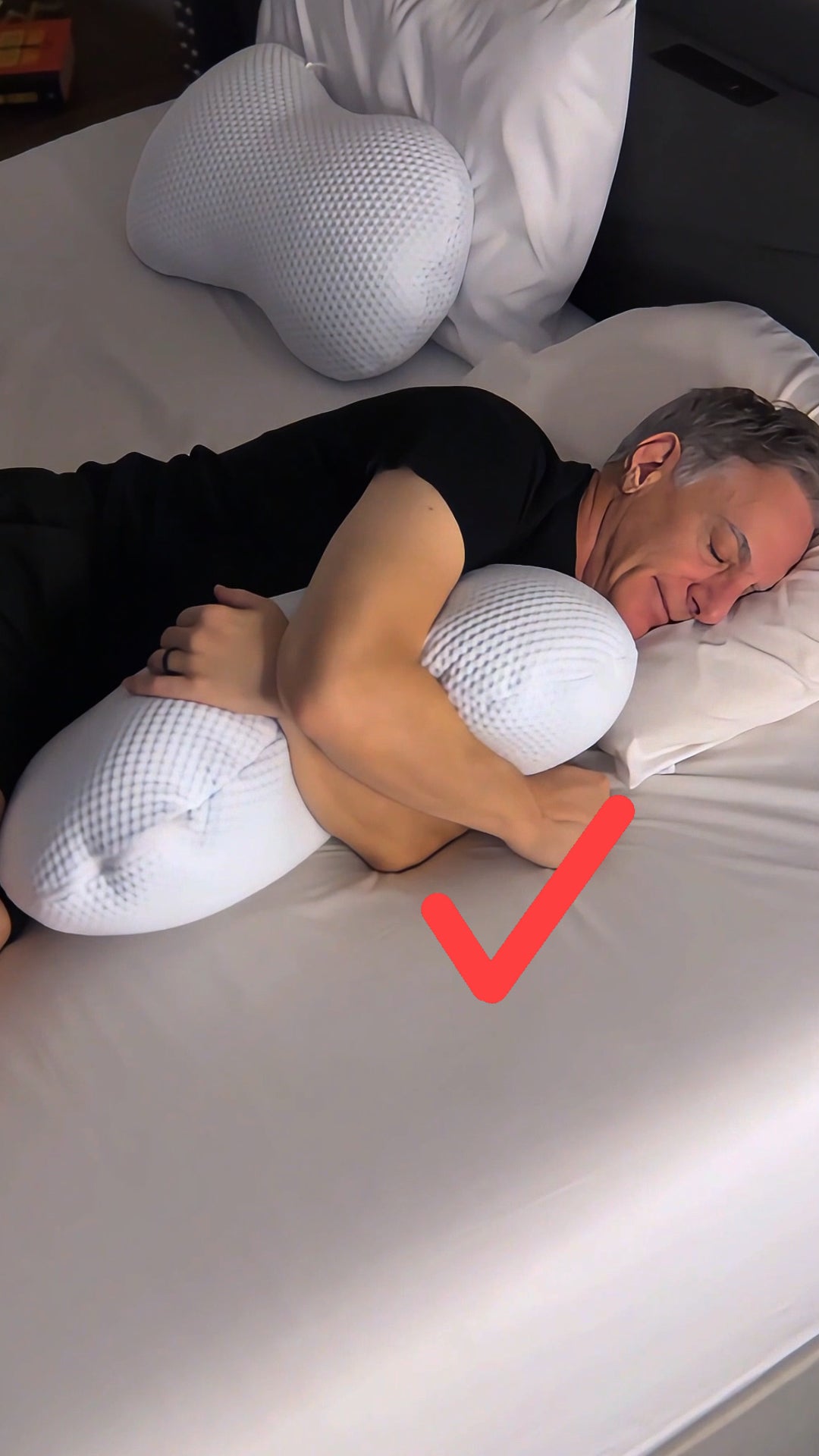 A man sound asleep with the clutcher therapeutic pillow for better support, spinal alignment and improved sleep 