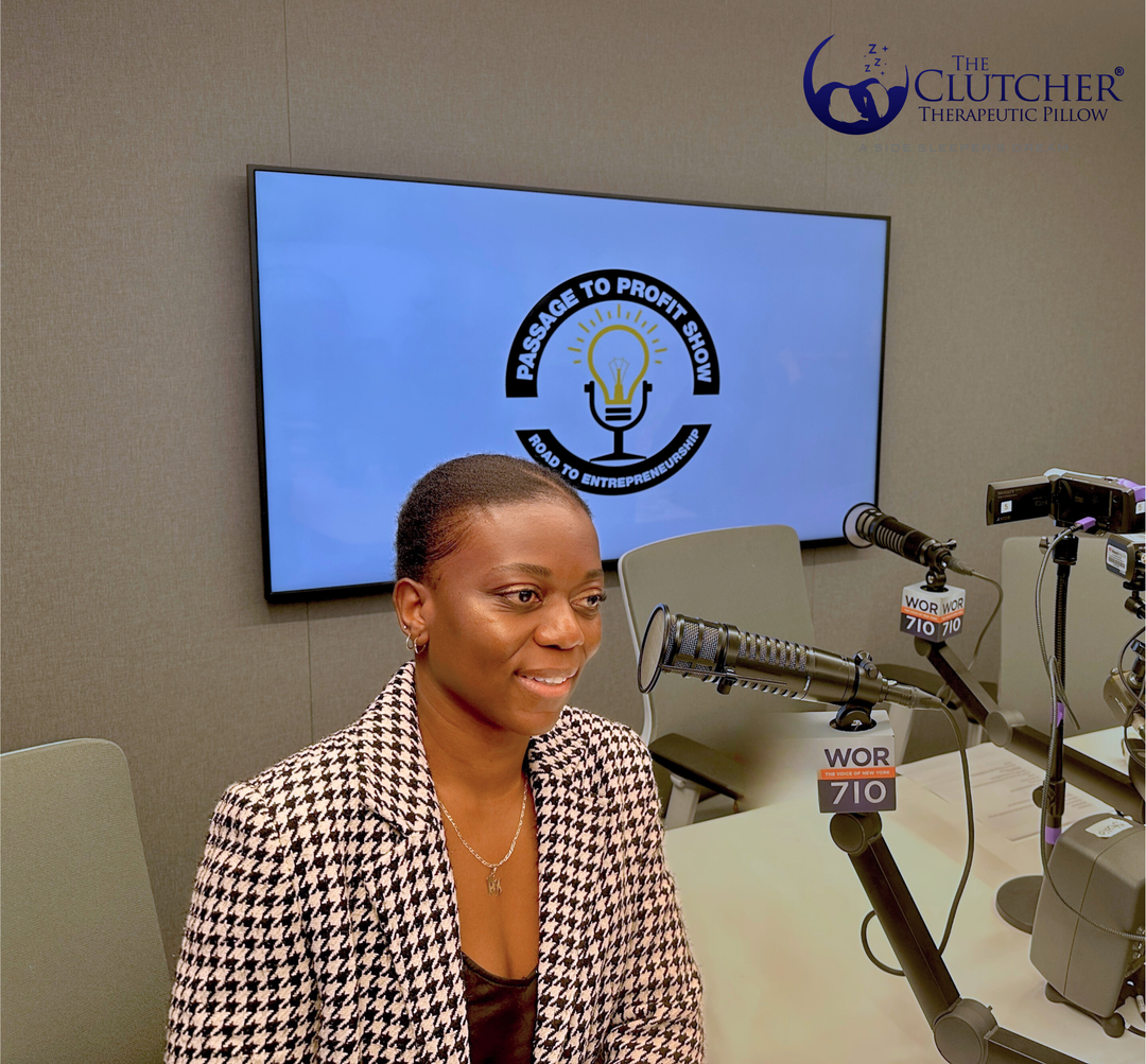 Alice Frankel, co-founder of The Clutcher Therapeutic Pillow®, speaking into a microphone during a Passage to Profit radio interview, sharing the story behind the side sleeper pillow invention.